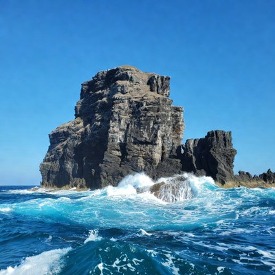 Ocean Waves Crashing on Towering Rock Formation