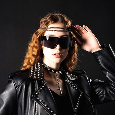 Woman in studded leather jacket with sunglasses