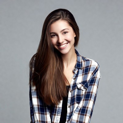 Smiling young woman in plaid shirt