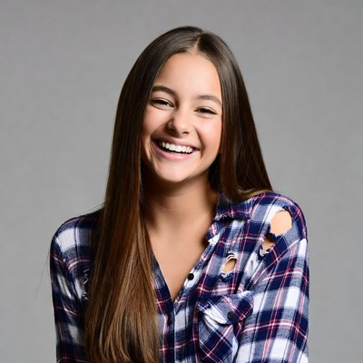 Smiling teenage girl in plaid shirt