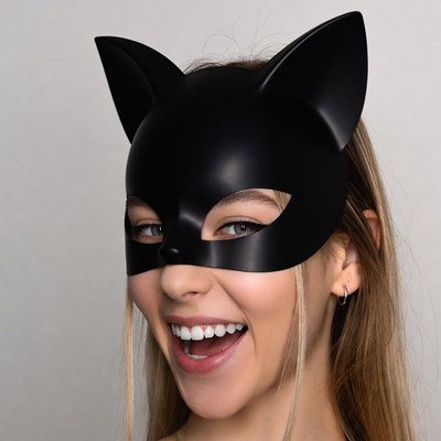 Woman smiling in black cat mask