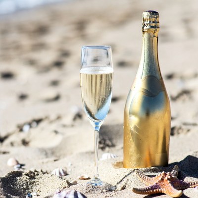 Champagne Glass and Bottle on Beach
