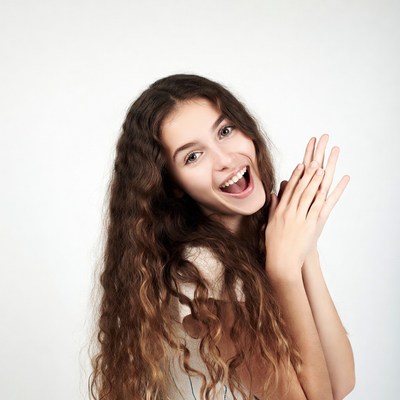 Young woman clapping hands excitedly
