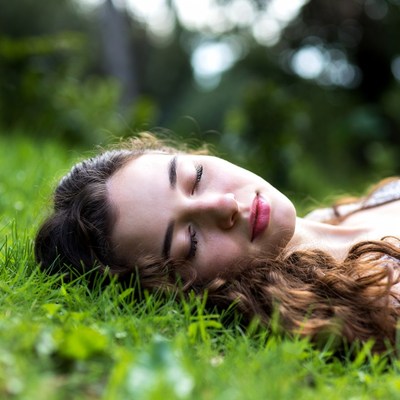 Young woman sleeping on grass