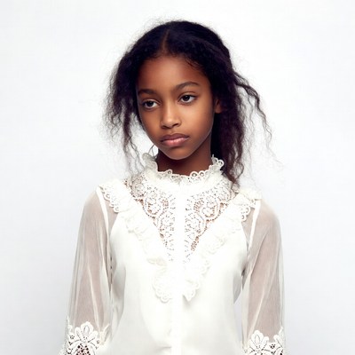 African-American girl in lace blouse
