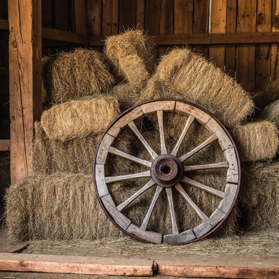 Old wagon wheel on hay bales