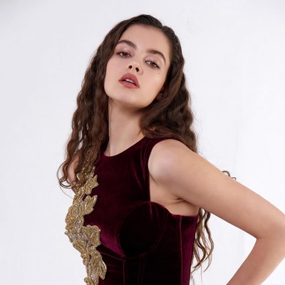 Woman in burgundy velvet dress