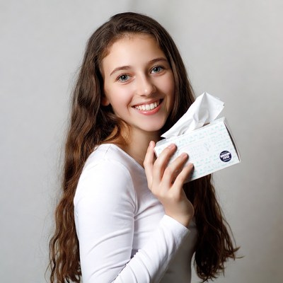 Smiling girl holding tissue box