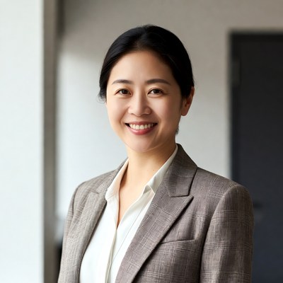 Asian woman in gray suit smiling