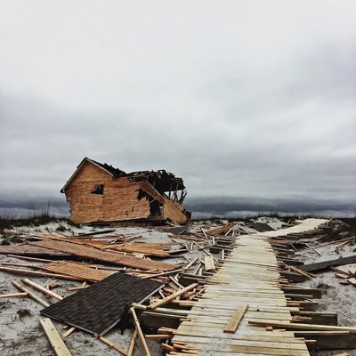 Destroyed Wooden House on Beach After Storm