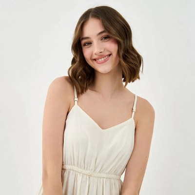 Smiling young woman in white dress