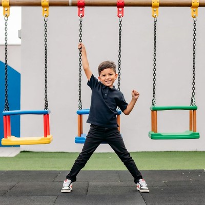 Boy swinging on playground swing