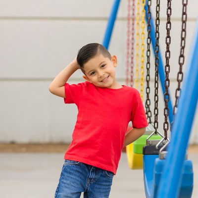 Latino boy posing at playground swings