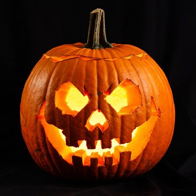 Lit Jack-o'-lantern pumpkin on black