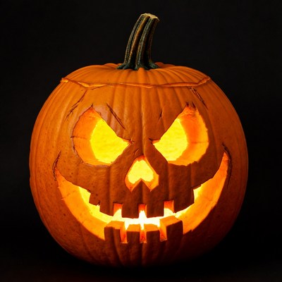 Lit Jack-o'-lantern pumpkin on black