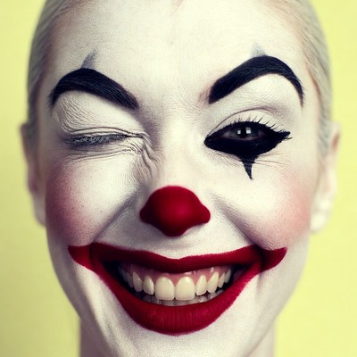 Woman winking in clown makeup