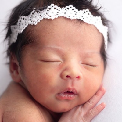 Sleeping Asian baby girl with lace headband