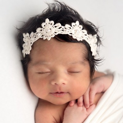 Newborn baby girl in lace headband