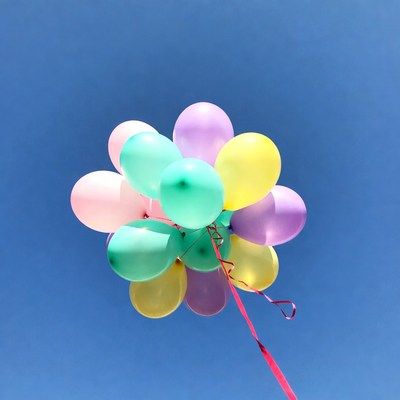 Colorful Balloons Floating in Blue Sky