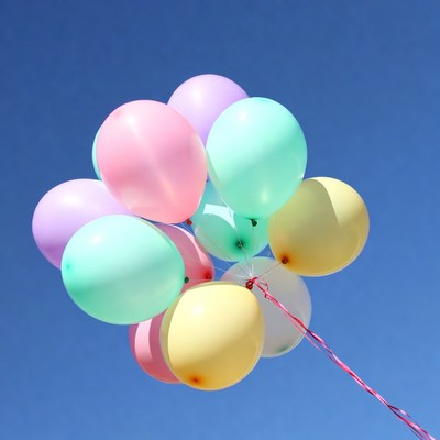 Colorful Balloons Floating in Blue Sky