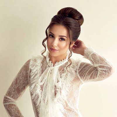 Woman in lace blouse with updo hairstyle