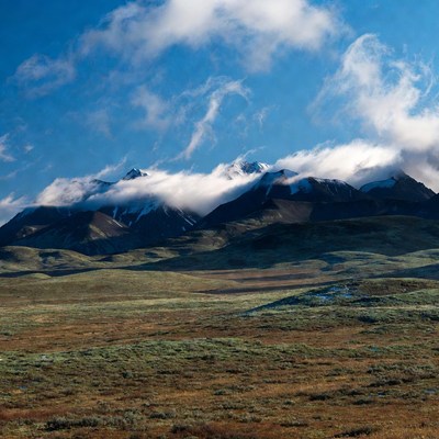 Snowy Mountains with Clouds and Tundra