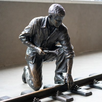 Bronze statue of man repairing railroad tracks