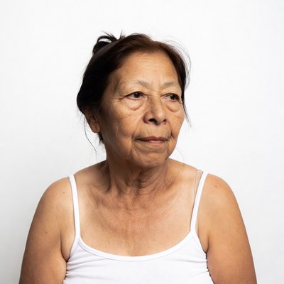 Elderly Asian woman in white tank top