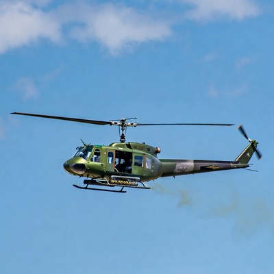 Military UH-1 Huey helicopter flying
