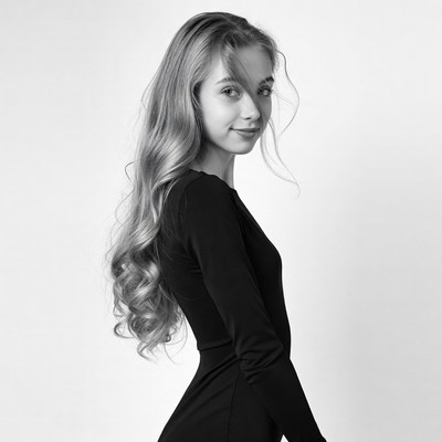 Blonde girl in black dress profile