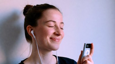 Woman listening to iPod with earphones