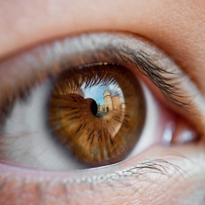 Eye reflecting tall building