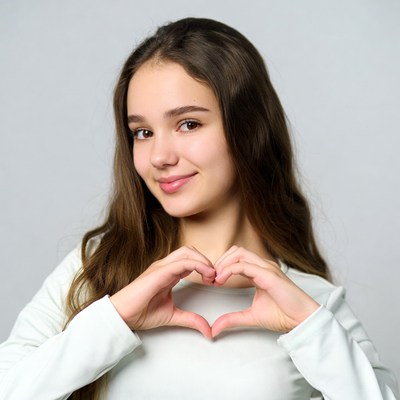 Teen girl making heart hands
