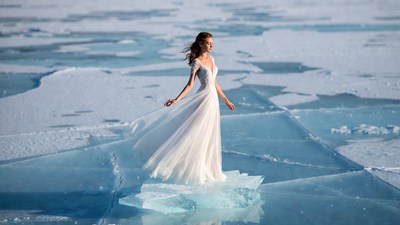 Woman in white wedding dress on ice