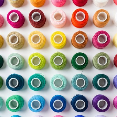 Colorful embroidery thread spools arranged neatly