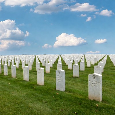 Rows of white gravestones in cemetery