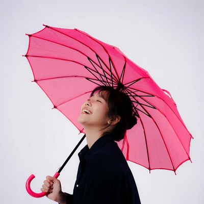 Asian woman holding pink umbrella
