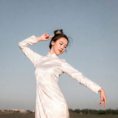 Asian woman in white qipao dancing