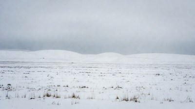 Snowy Hills Under Gray Sky
