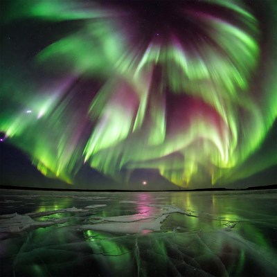 Vibrant Green Aurora Borealis over Frozen Lake