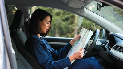 Woman reading map in car