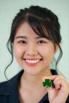 Asian woman holding green shamrock
