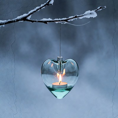 Heart-shaped glass lantern with candle