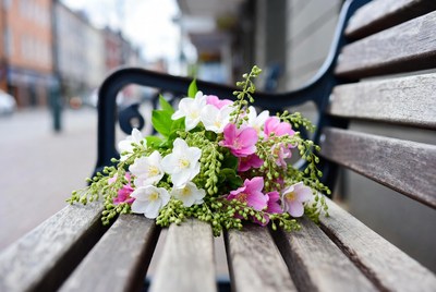 Bouquet of white and pink flowers on bench