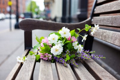 Bouquet of white and pink flowers on wooden bench