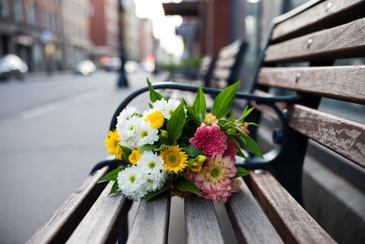 Colorful flowers bouquet on park bench