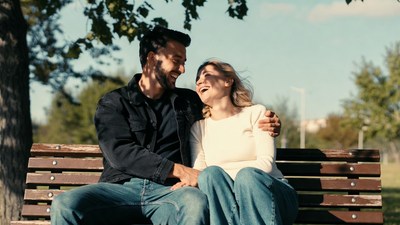 Couple embracing on park bench