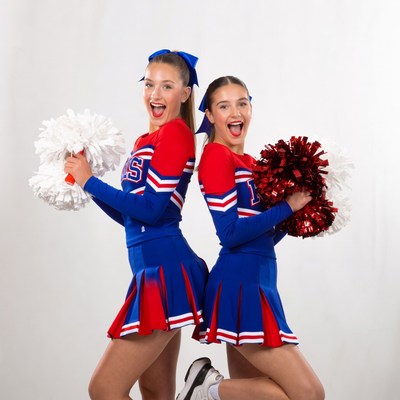 Two cheerful girls in cheerleader uniforms