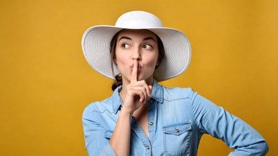 Woman shushing with finger over lips