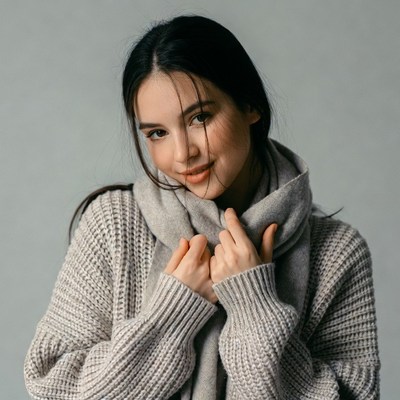 Asian woman in gray scarf and sweater